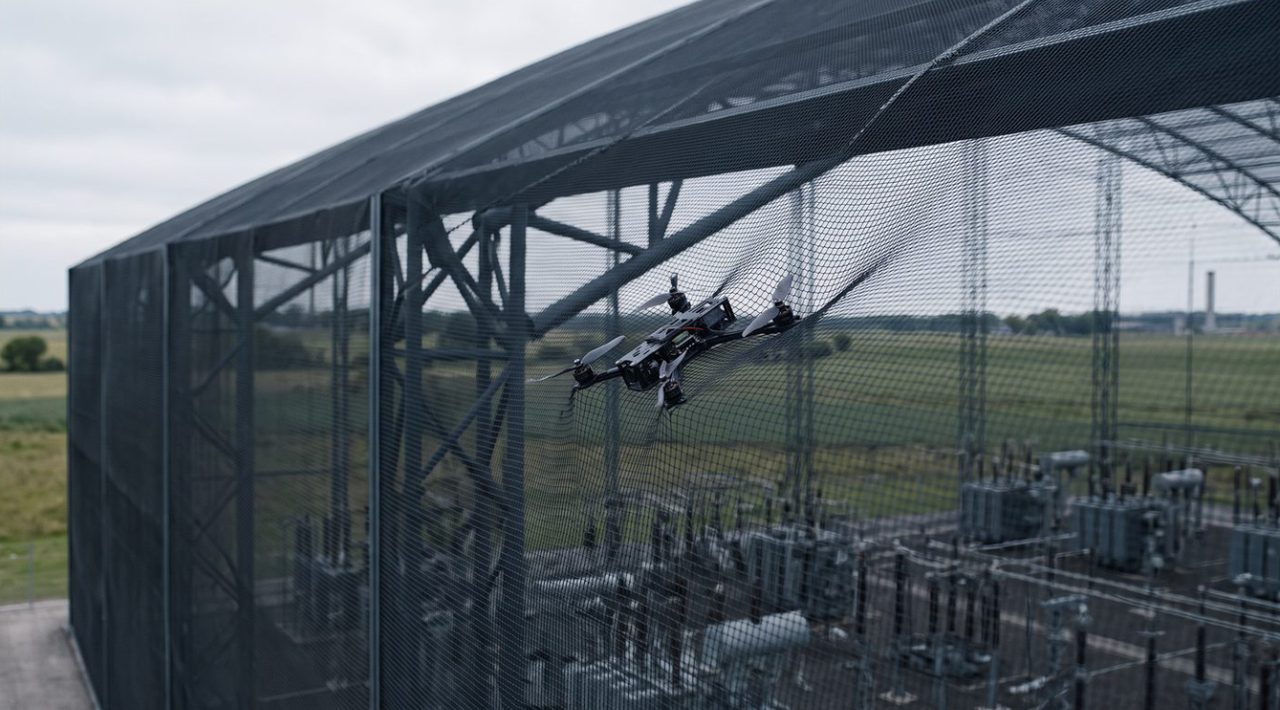 A drone meeting the protective net above a substation