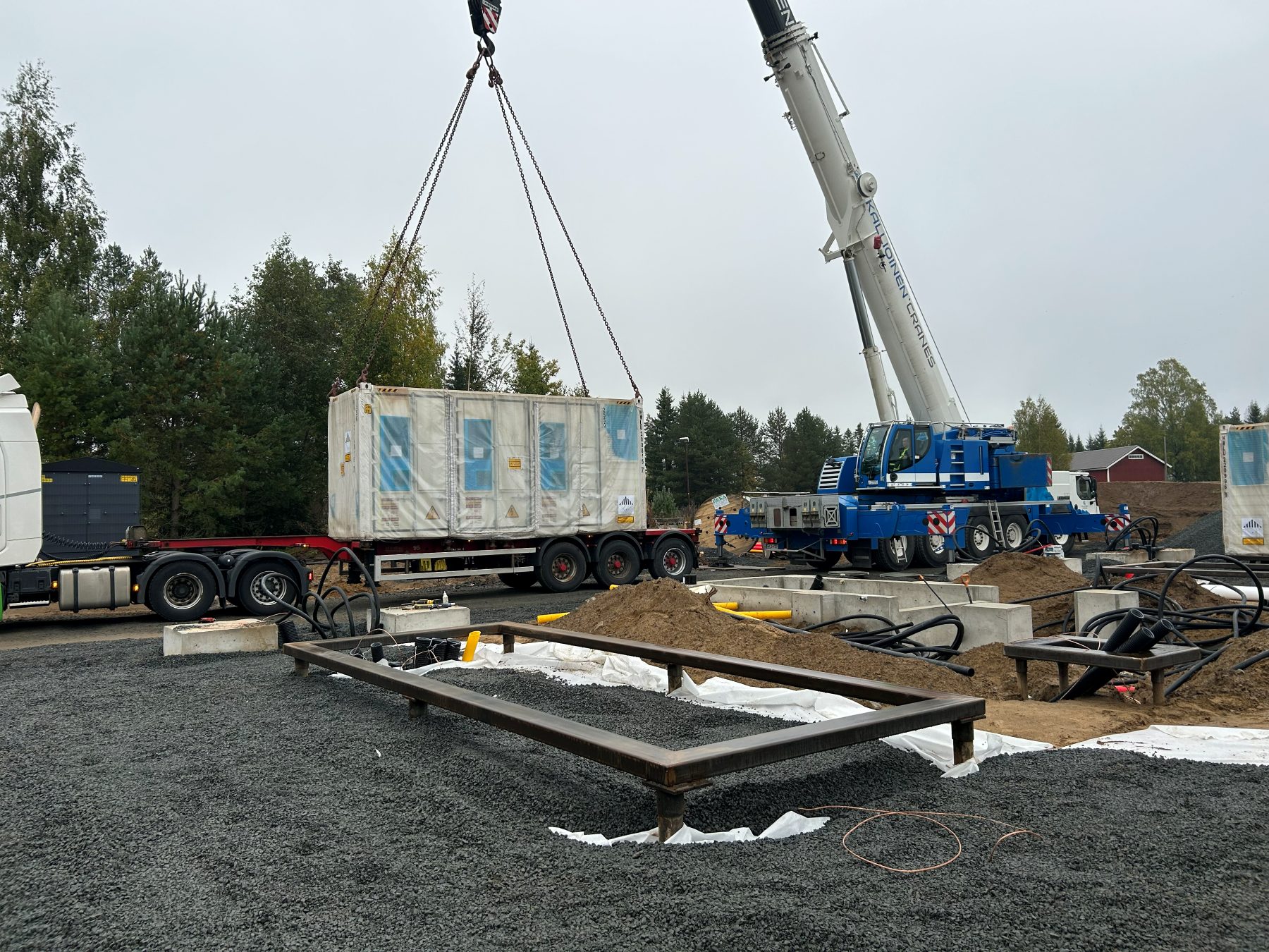 Loppi BESS — container being craned onto helical pile foundation, Finland